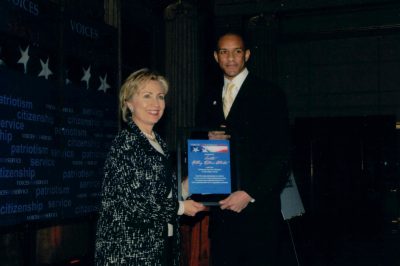 Wilfred Stephen Anfield presents the Edward M. Kennedy National Service Lifetime Leadership Award to Senator Hillary Rodham Clinton at the Friends of National Service Awards Reception in Washington, D.C., 2007.